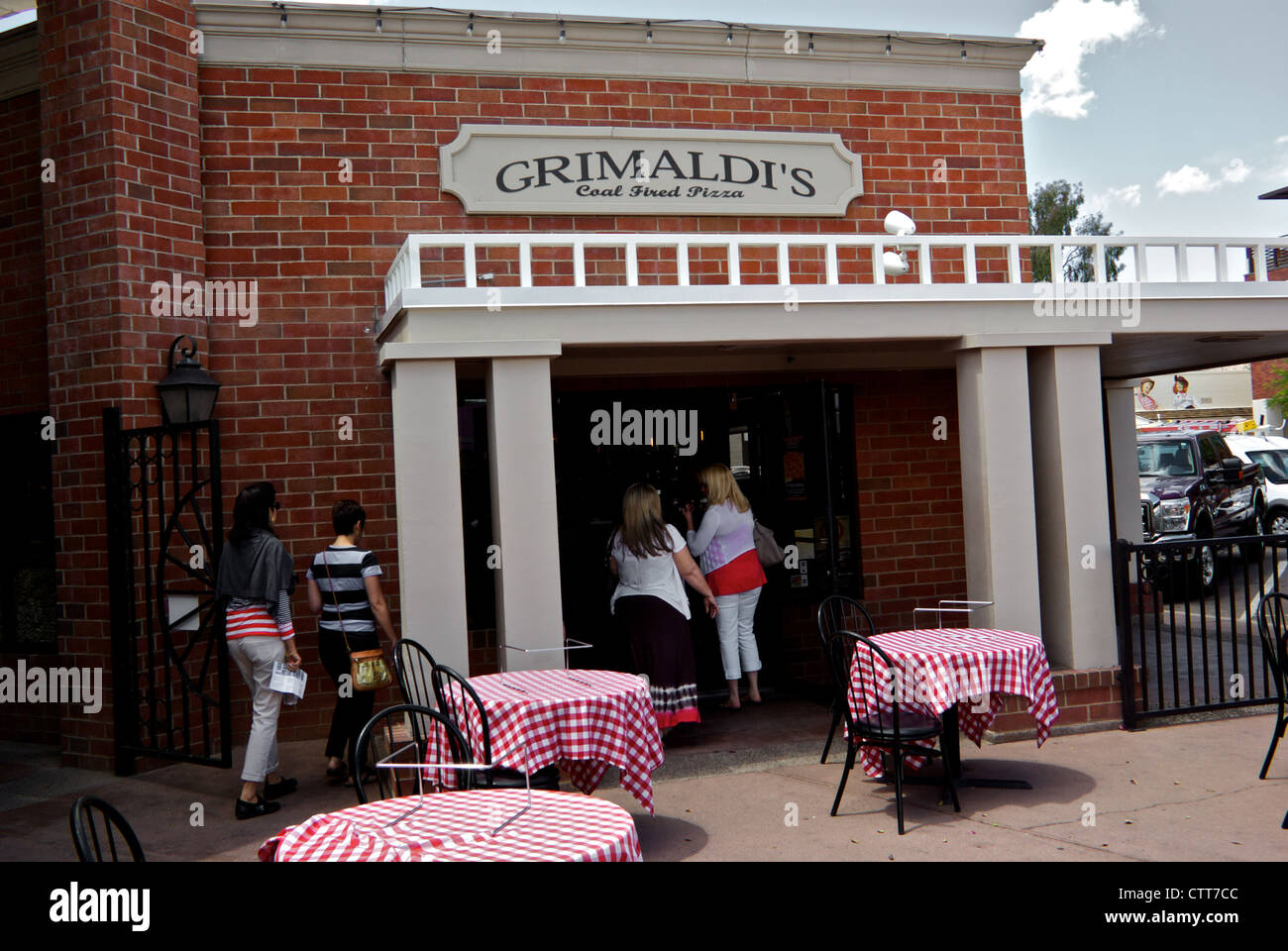 Tourists entering Grimaldi's Coal Fired Pizza parlour entrance patio dinig area Old Town Scottsdale AZ Stock Photo