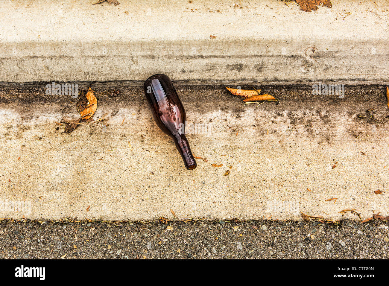 empty wine bottle in gutter at curb Stock Photo Alamy