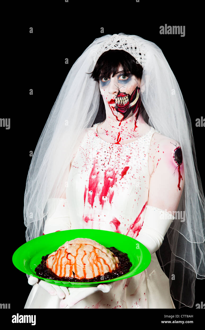 A zombie bride prepares to serve brains to her groom Stock Photo