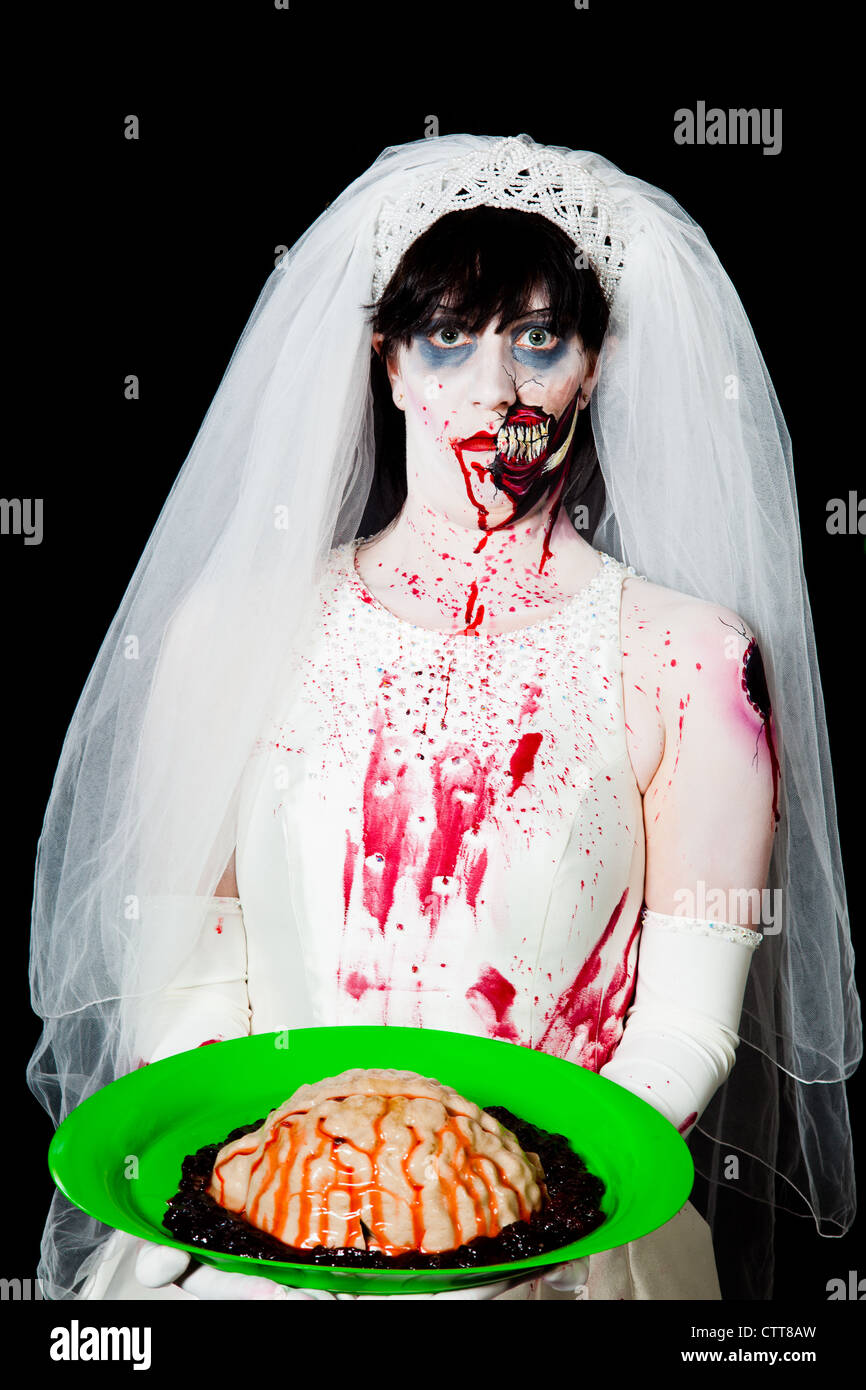 A zombie bride prepares to serve brains to her groom Stock Photo
