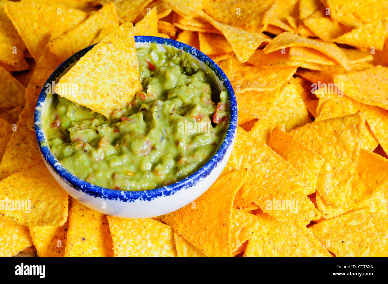 Nacho chips with fresh guacamole dip Stock Photo