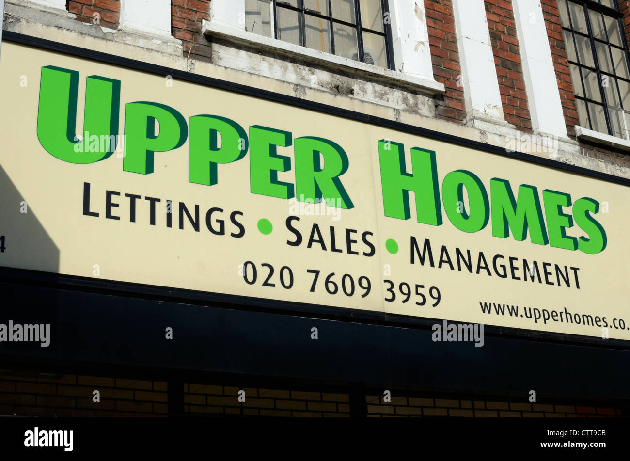 ' Upper Homes ' sign above an estate agents' office, Islington, London