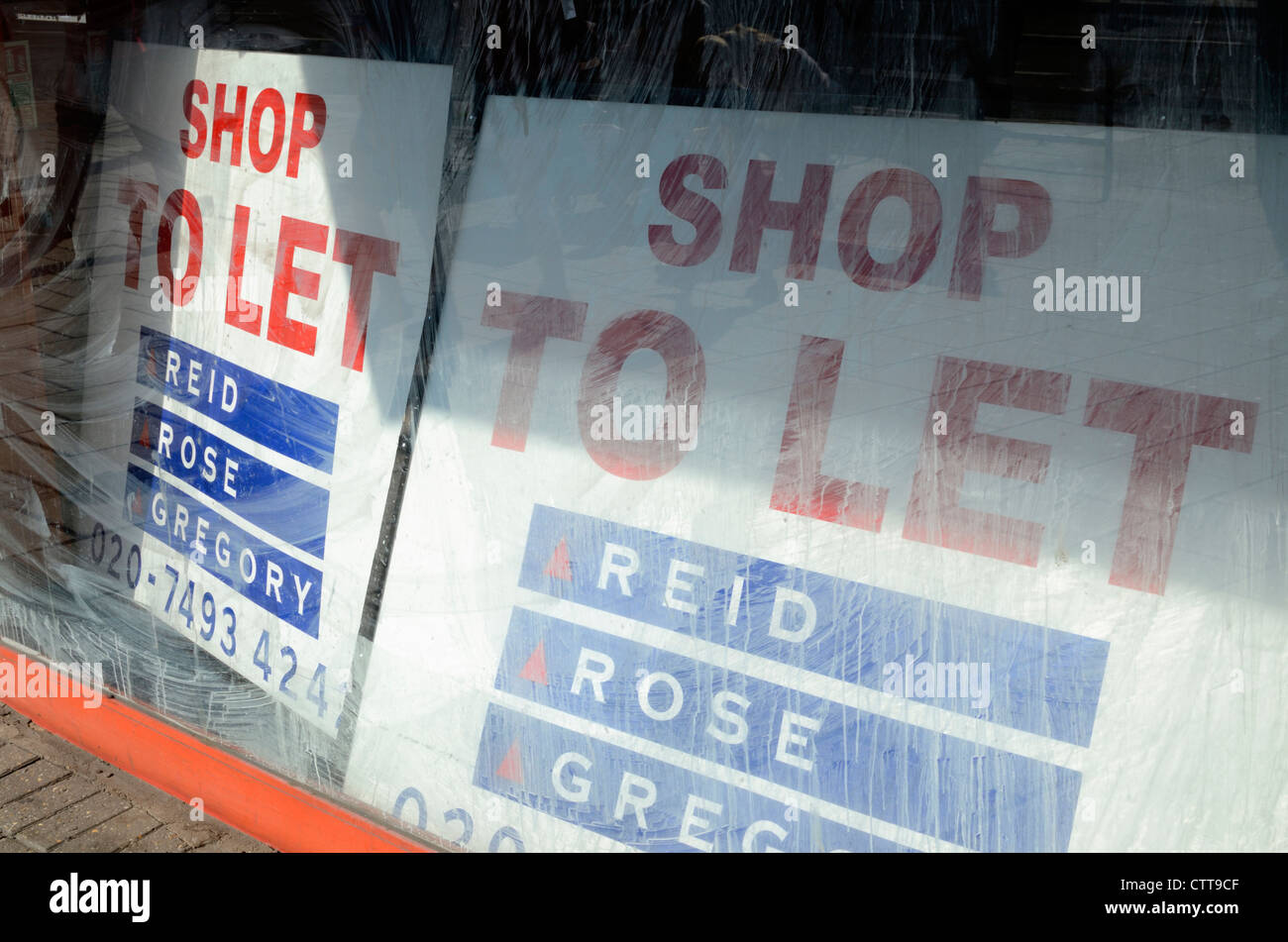 ' Shop to Let ' signs in a shop window, London, UK Stock Photo