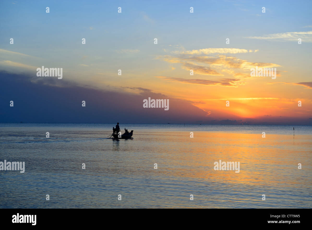 Fisherman are taking fishing boat to fish with sunrise background. Stock Photo