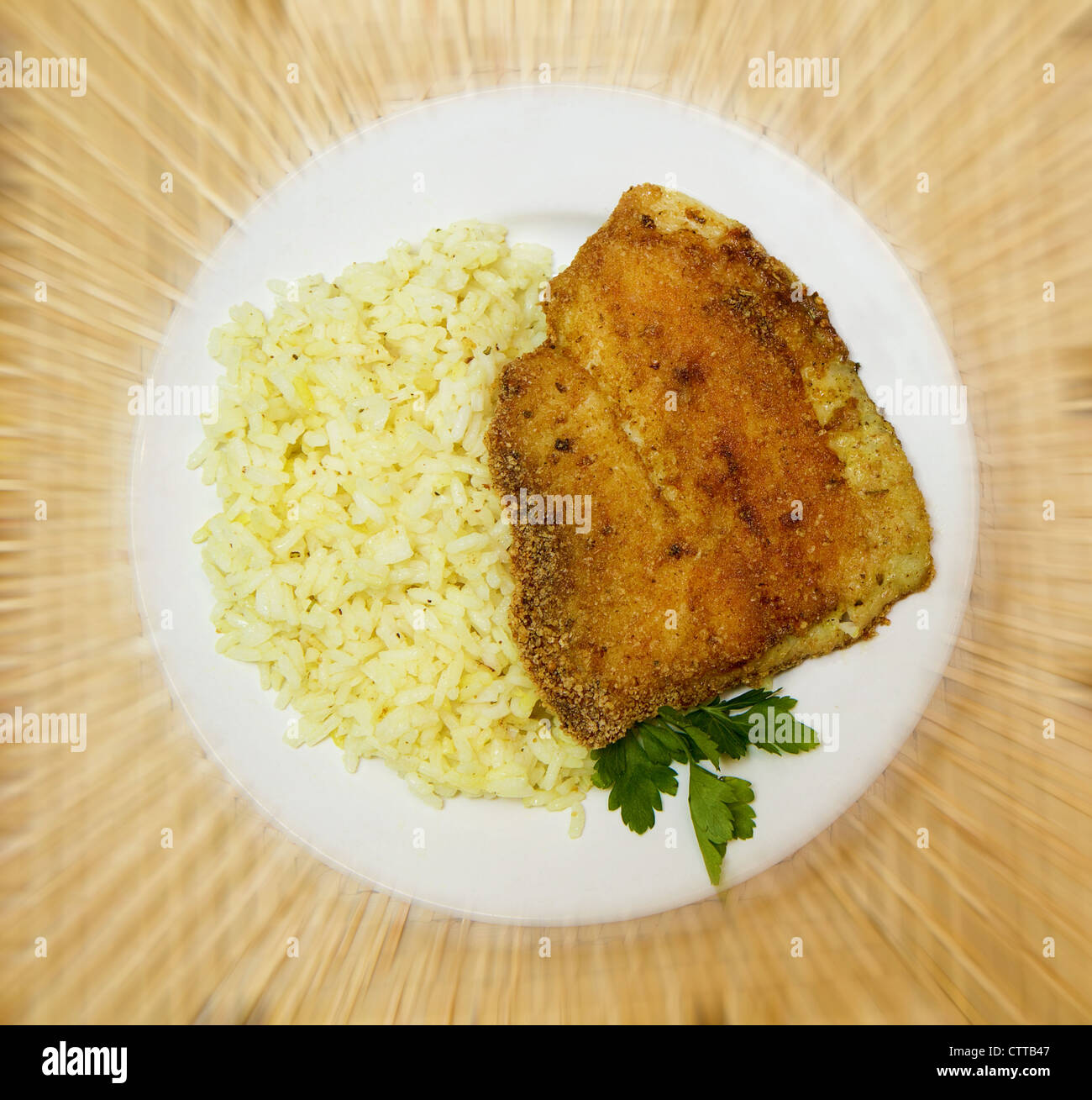 fried breaded tilapia served with rice and herbs Stock Photo Alamy