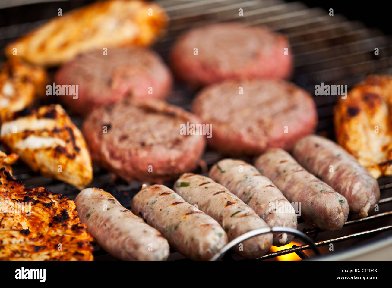 BBQ with burgers, chicken and sausages Stock Photo Alamy
