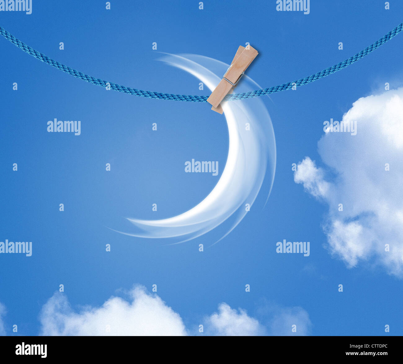 A fantasy cloudscape a crescent moon hanging on rope between clouds. Stock Photo