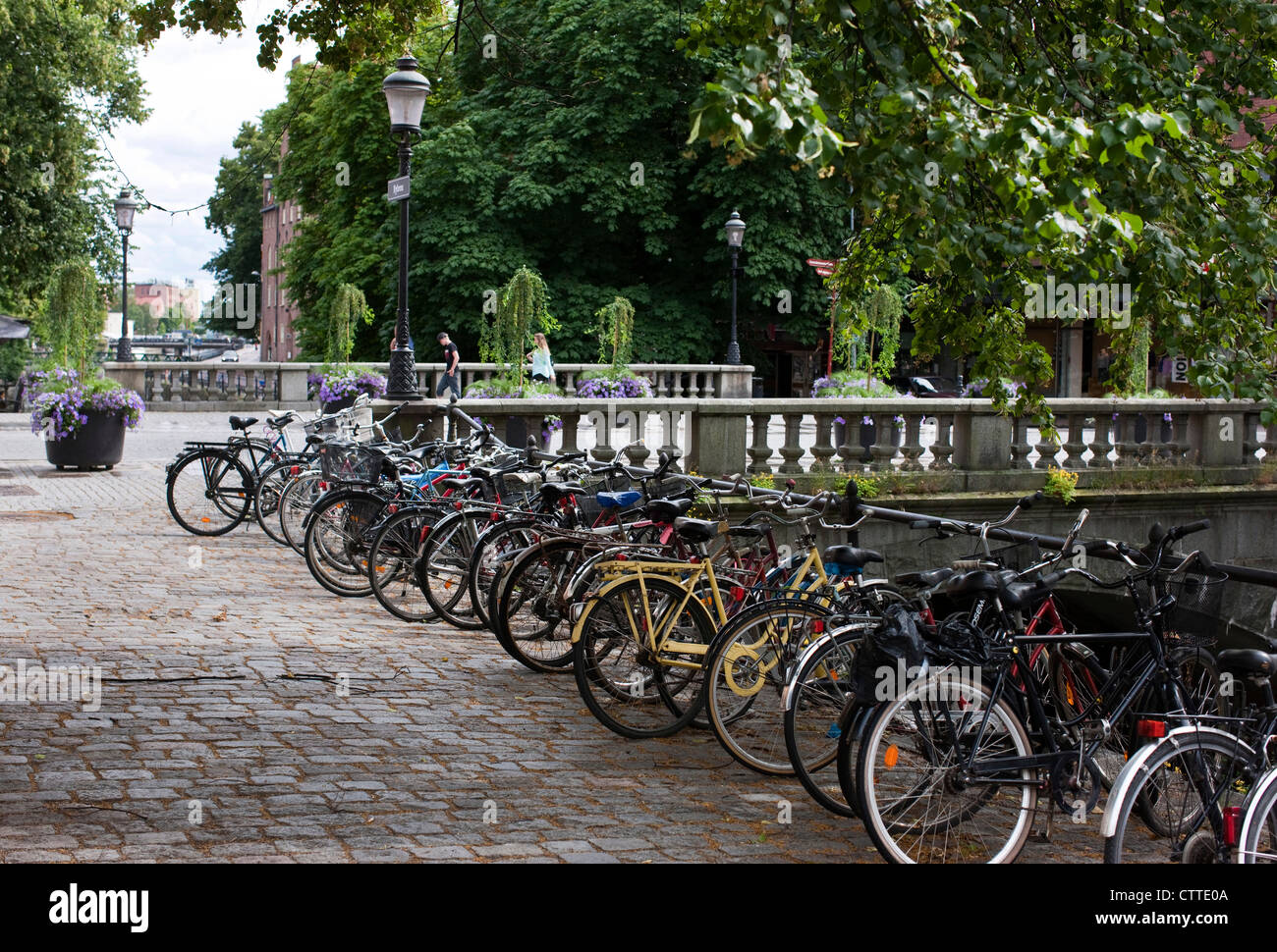 Bicycles racked up next to the Fyris river. Uppsala, Sweden. Stock Photo