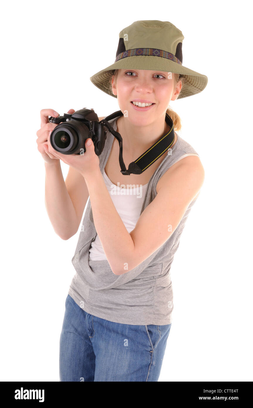 Casual smiling girl-tourist with digital photo camera is looking for picture on white background Stock Photo