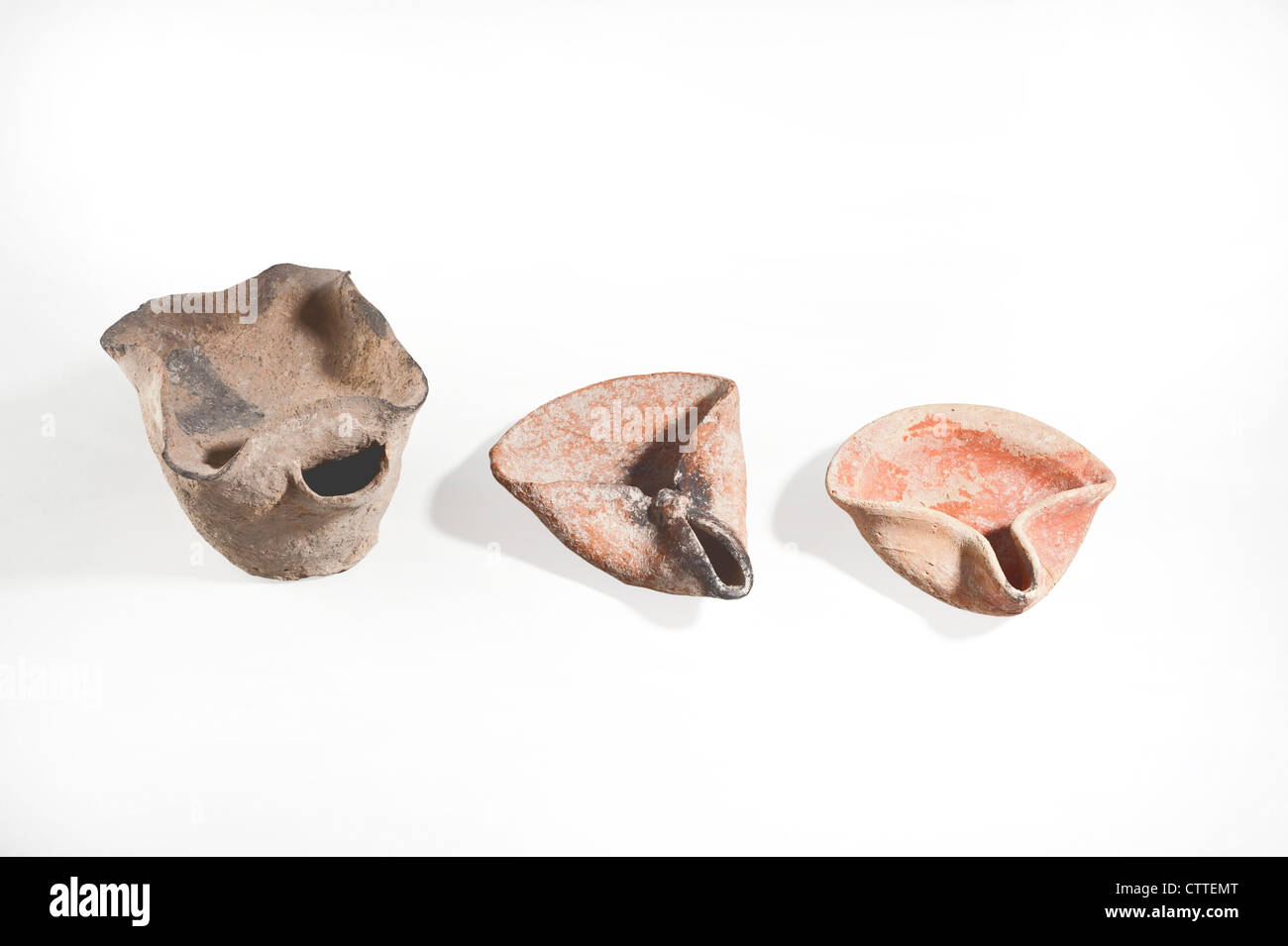 Ancient oil lamps Bronze Age 2000 BCE on the left and two Iron Age terracotta 8-10 century BCE Stock Photo