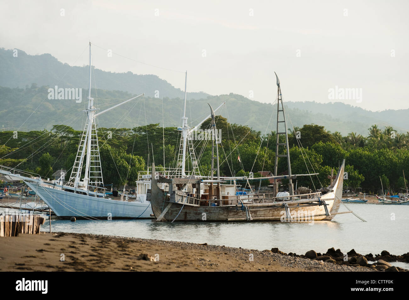 An exotic purse seine fishing boat called a Prahu Madura is docked in the fishing village of Pemuteran, Bali, Indonesia. Stock Photo