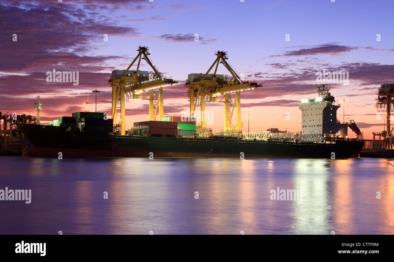 Container Cargo freight ship with working crane bridge in shipyard at ...