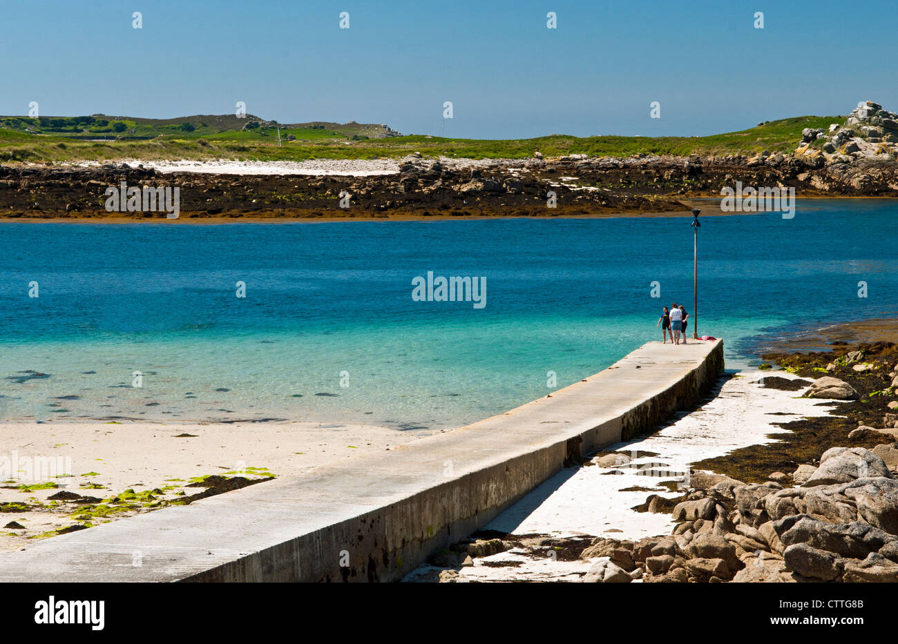 Lower Town Quay on St Martins Isles of Scilly with three people on the