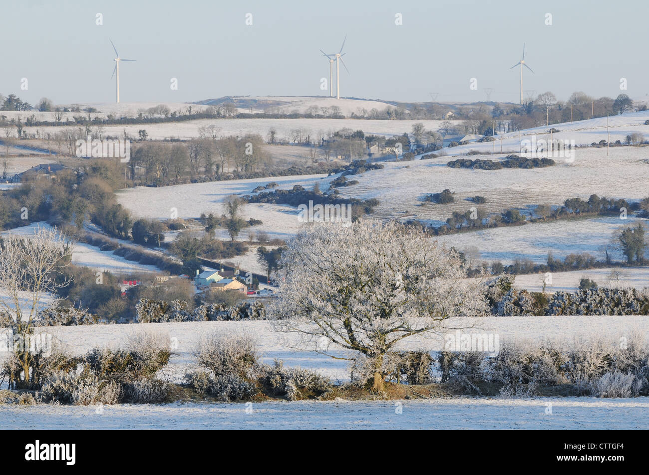 Wind turbines on the horizon of a snow covered landscape, Mount Oriel, Collon, County Louth, Ireland Stock Photo