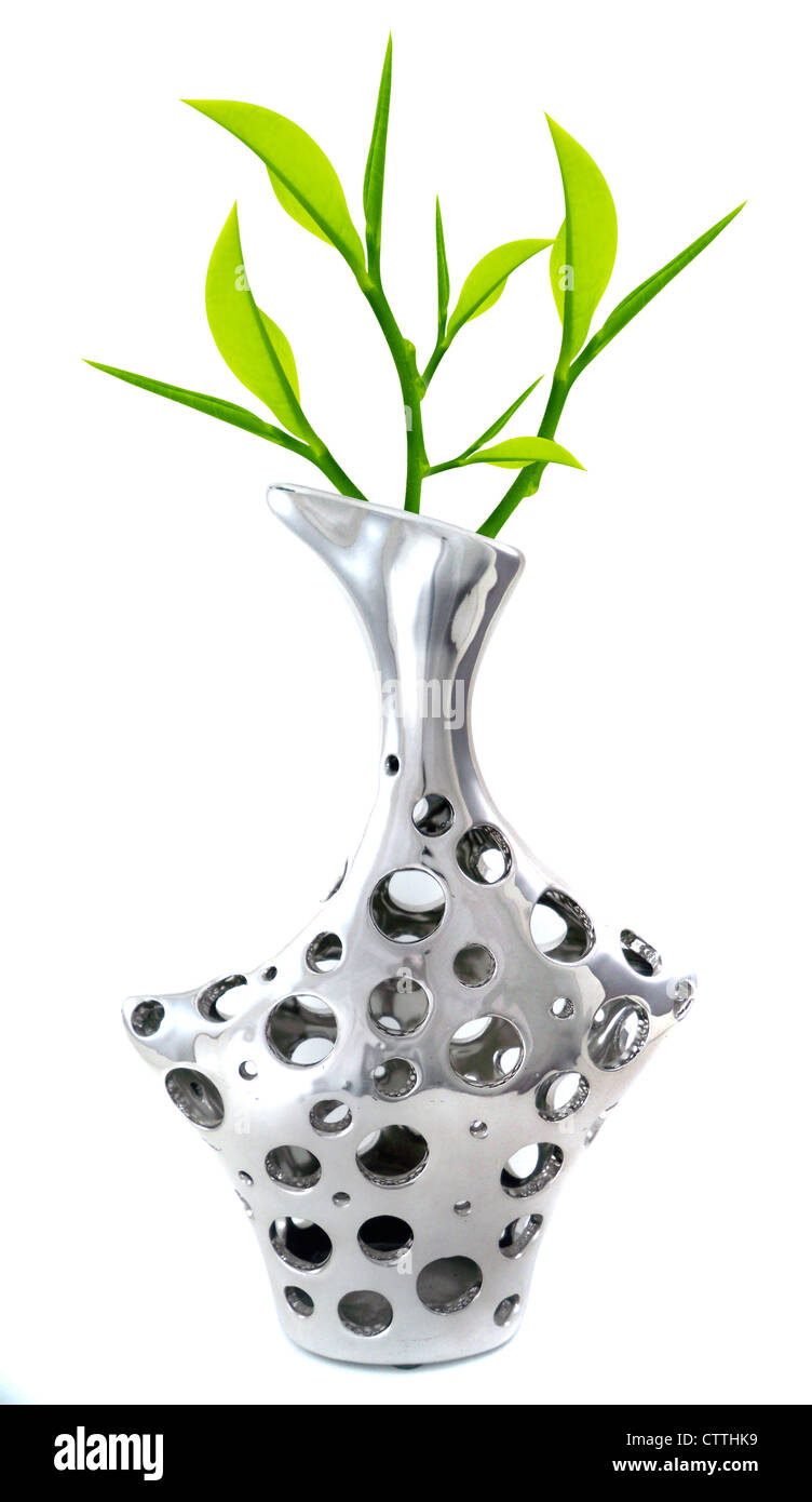 stylish and modern Silver Vase with green twigs isolated on white. Stock Photo
