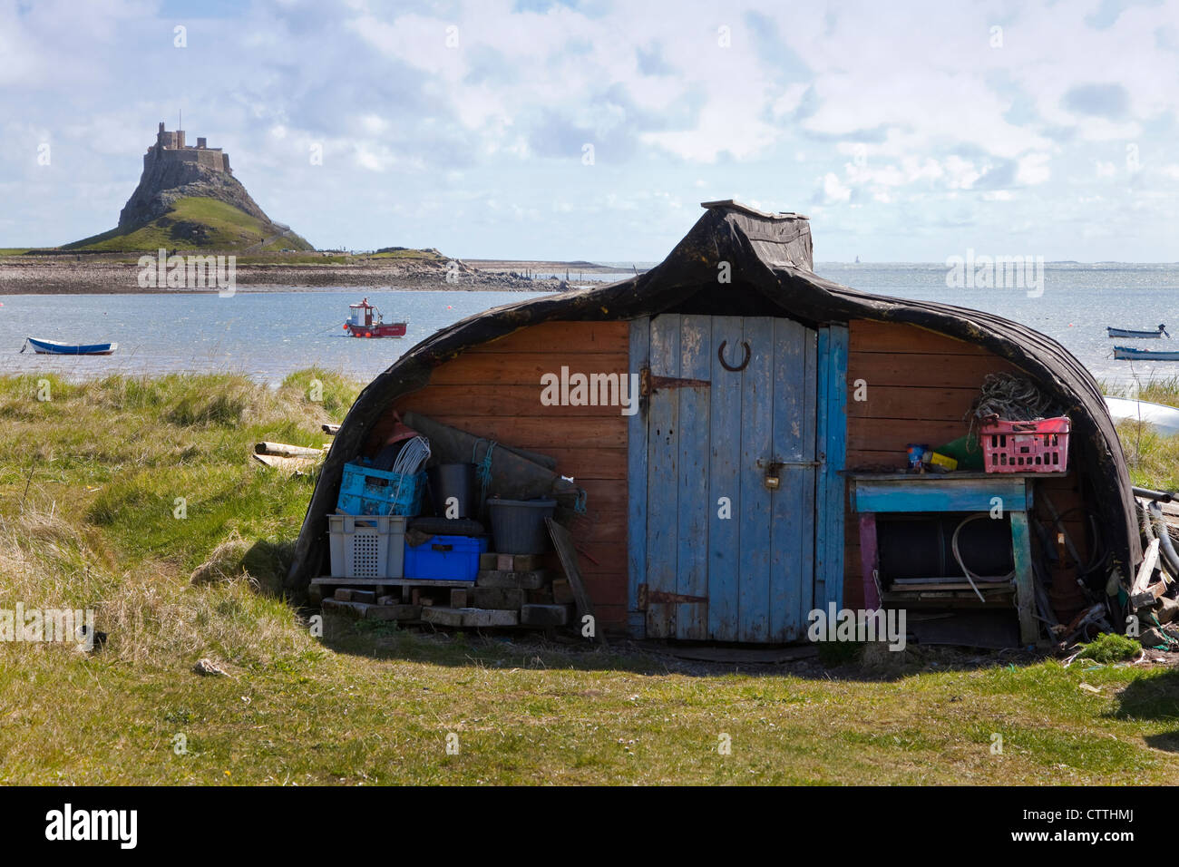 Fisherman's storage shed made from an upturned boat, Lindisfarne Castle, Northumberland, England, UK, Great Britain Stock Photo