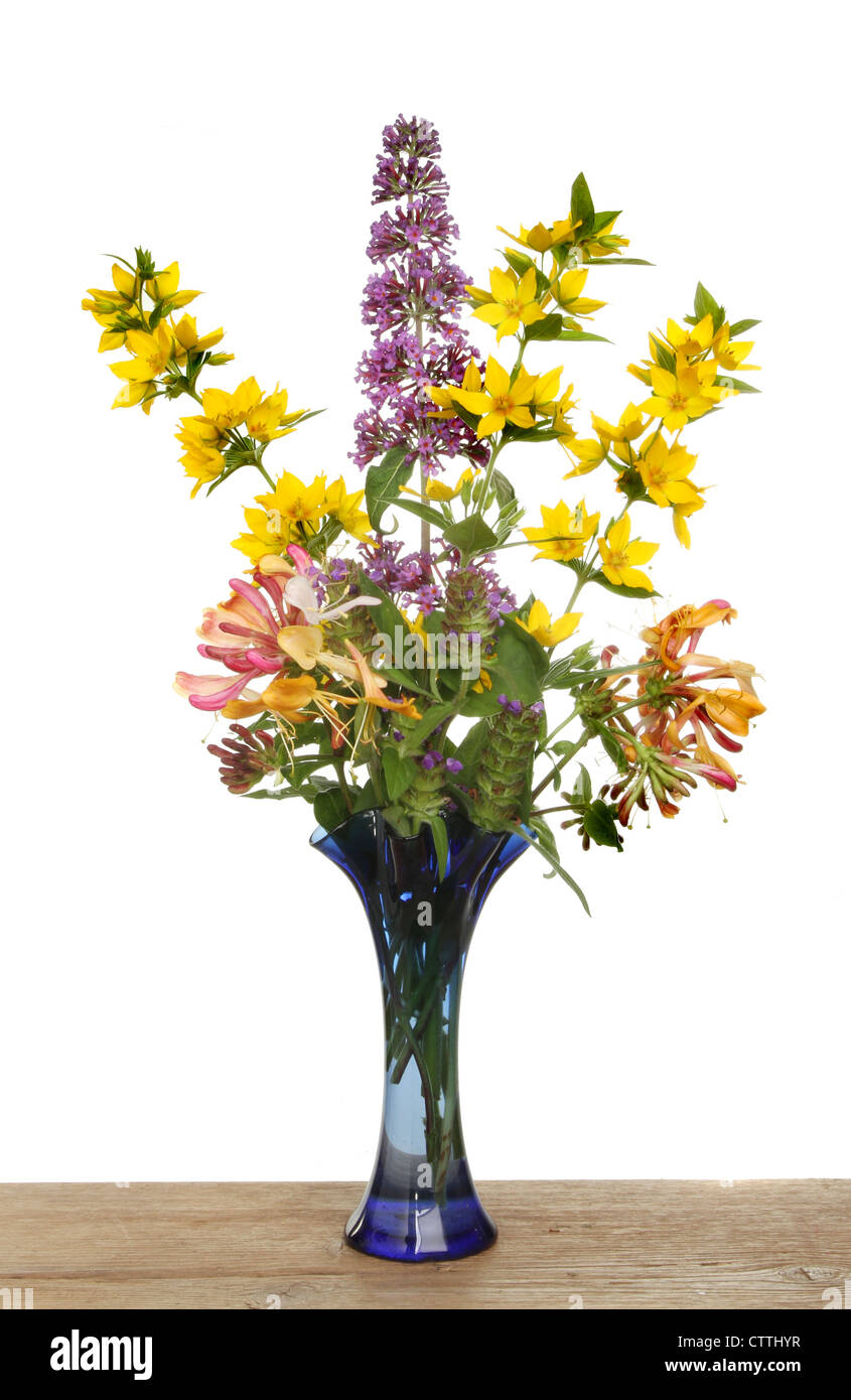 Arrangement of wild flowers in a blue glass vase Stock Photo Alamy
