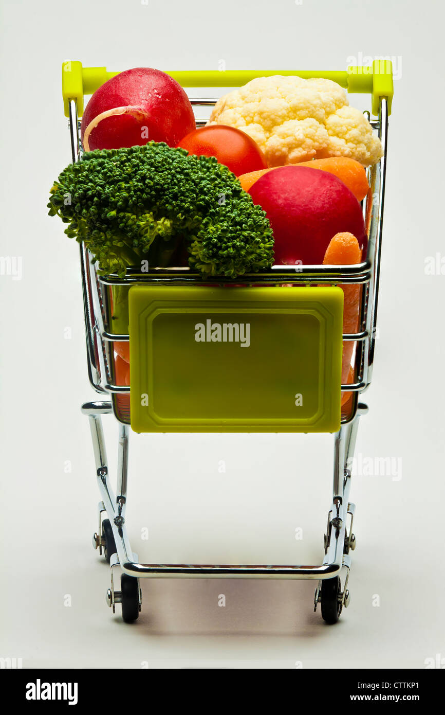 miniature shopping cart full of vegetables Stock Photo