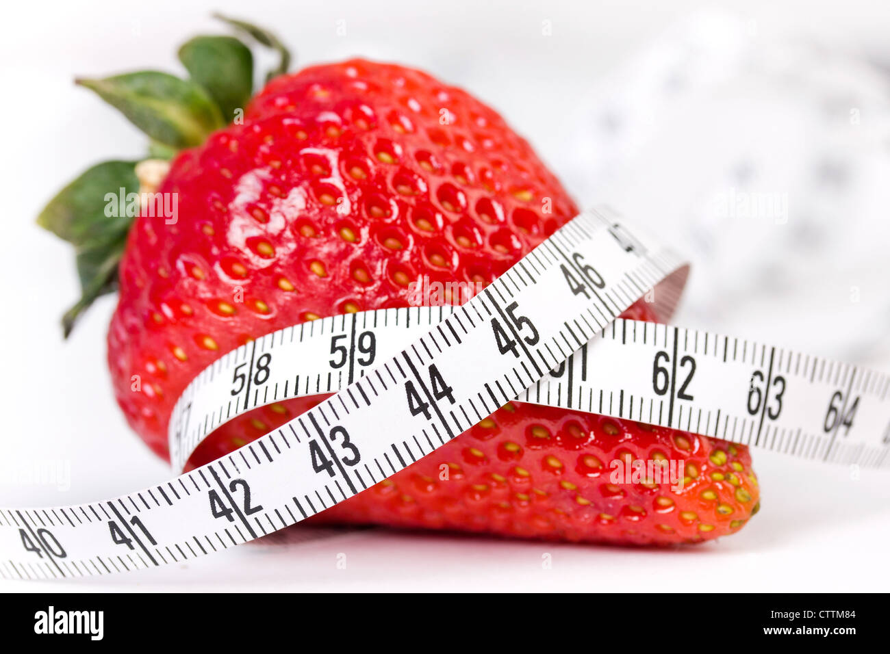 Strawberry with measure tape, closeup on white background Stock Photo ...