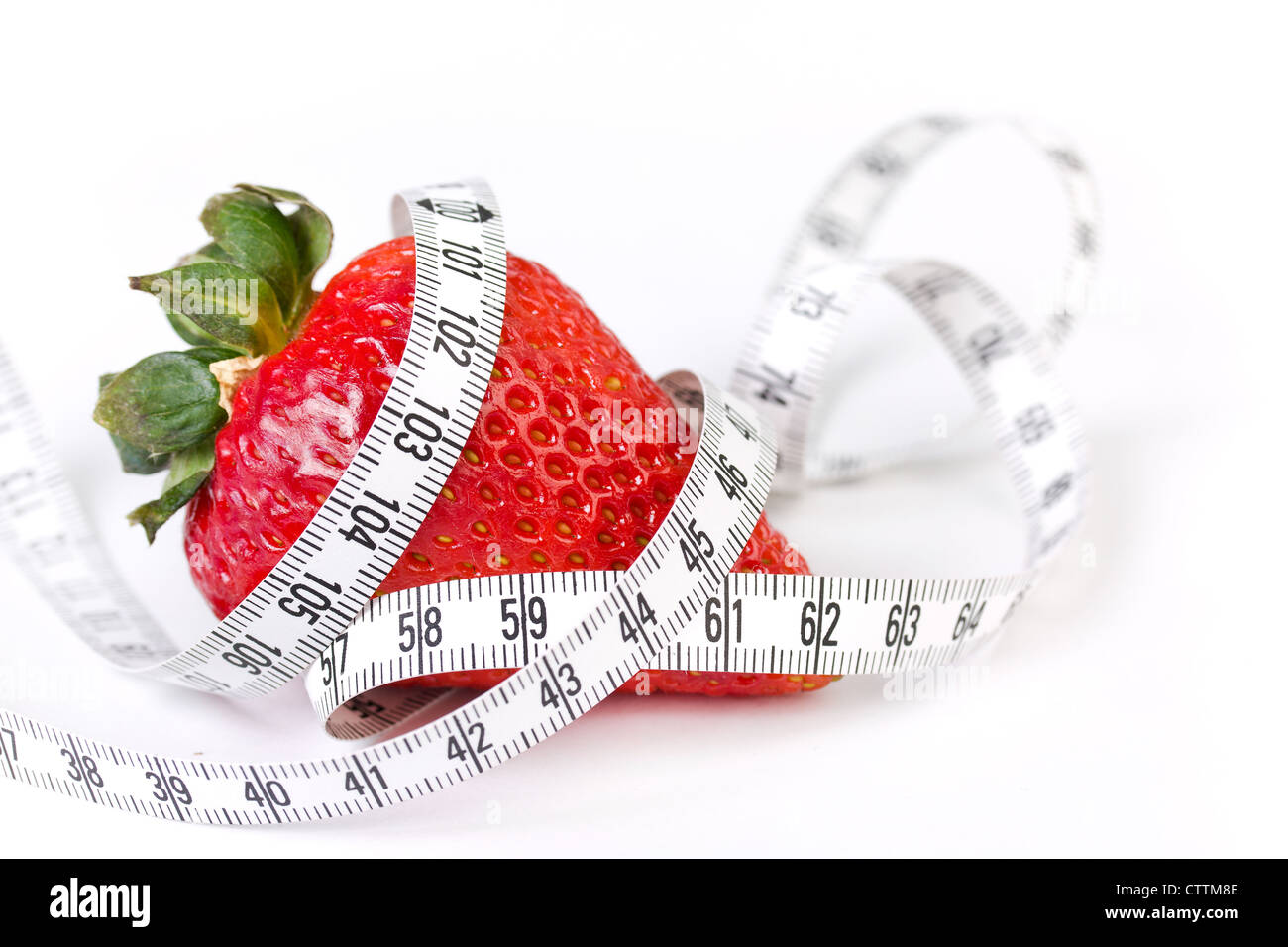 Strawberry with measure tape, closeup on white Stock Photo - Alamy