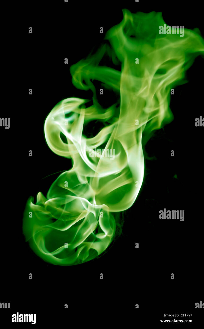greenish fire with a black background, abstract background. Stock Photo
