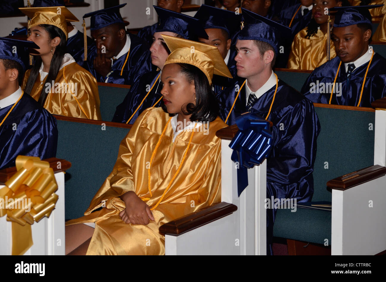 High school graduates listen to speakers at their high school