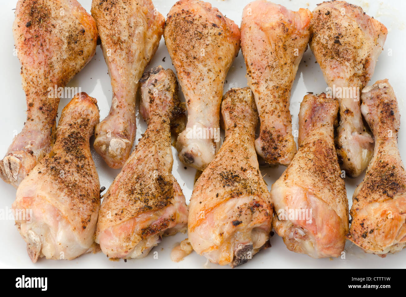 A tray of oven roasted chicken legs studio shot Stock Photo Alamy