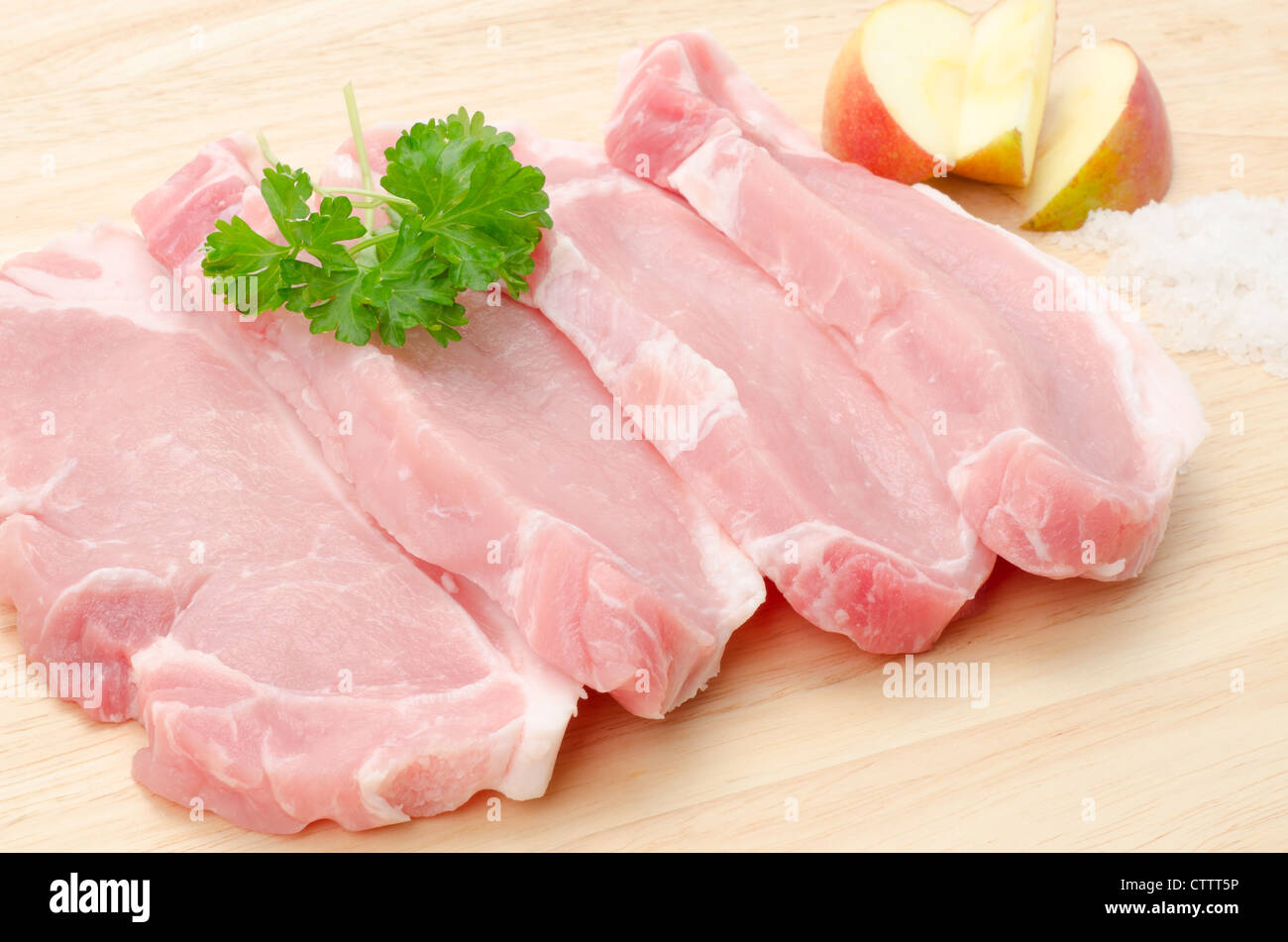 Uncooked pork loin on a wooden cutting board - studio shot Stock Photo