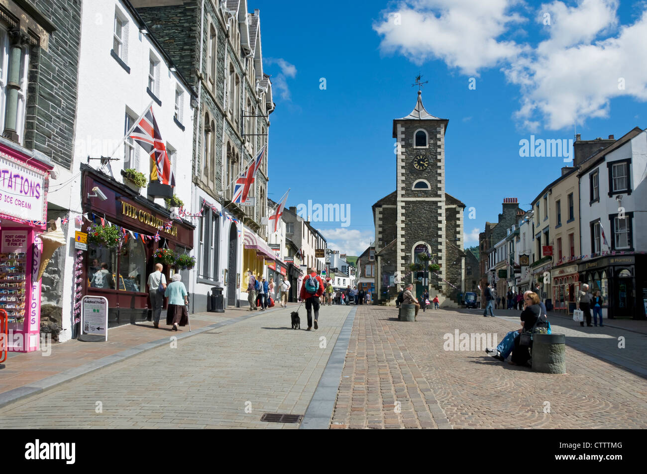 Shops stores and Moot Hall in summer Market Square Keswick town centre