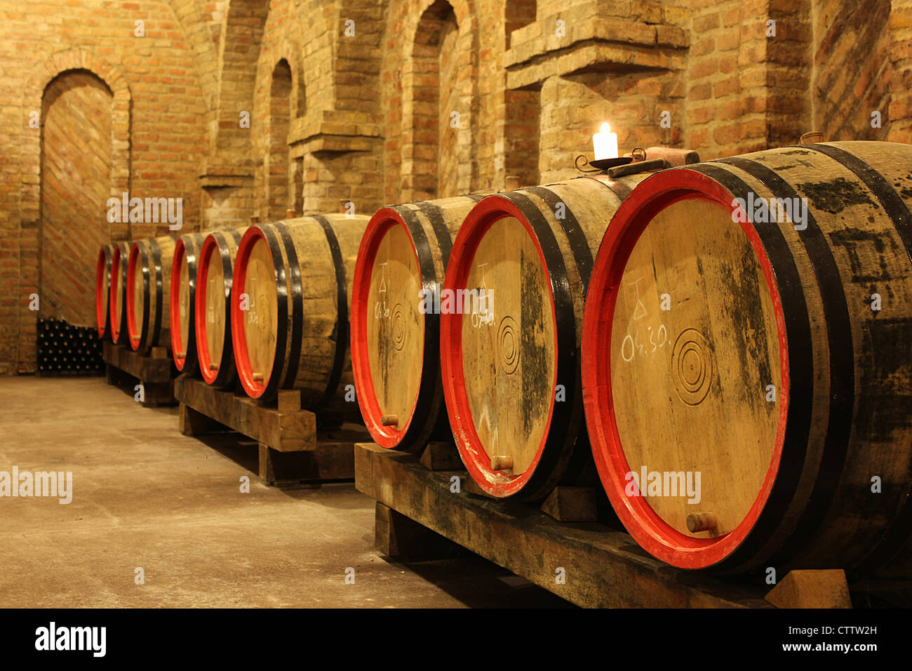 wine barrels and bottles in a cellar Stock Photo Alamy