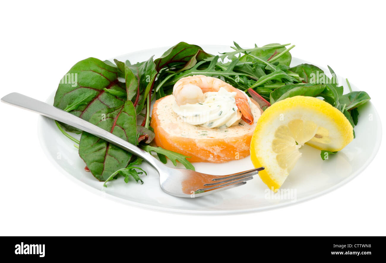 Prawn, salmon, crab and lobster mousse wrapped in smoked salmon served with a green salad and a twist of lemon Stock Photo