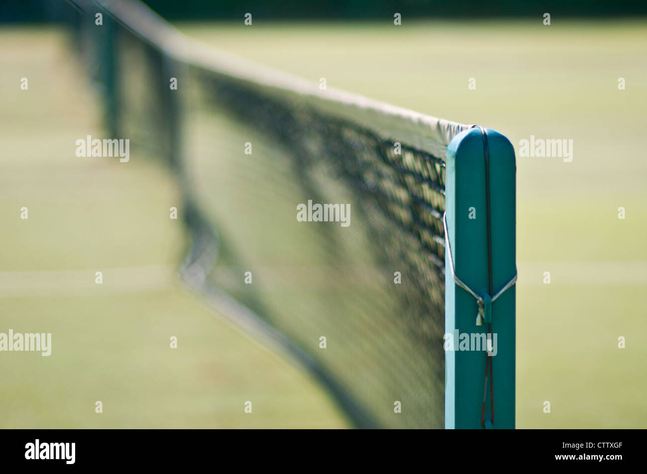 Looking through the perimeter fence onto a tennis court Stock Photo Alamy