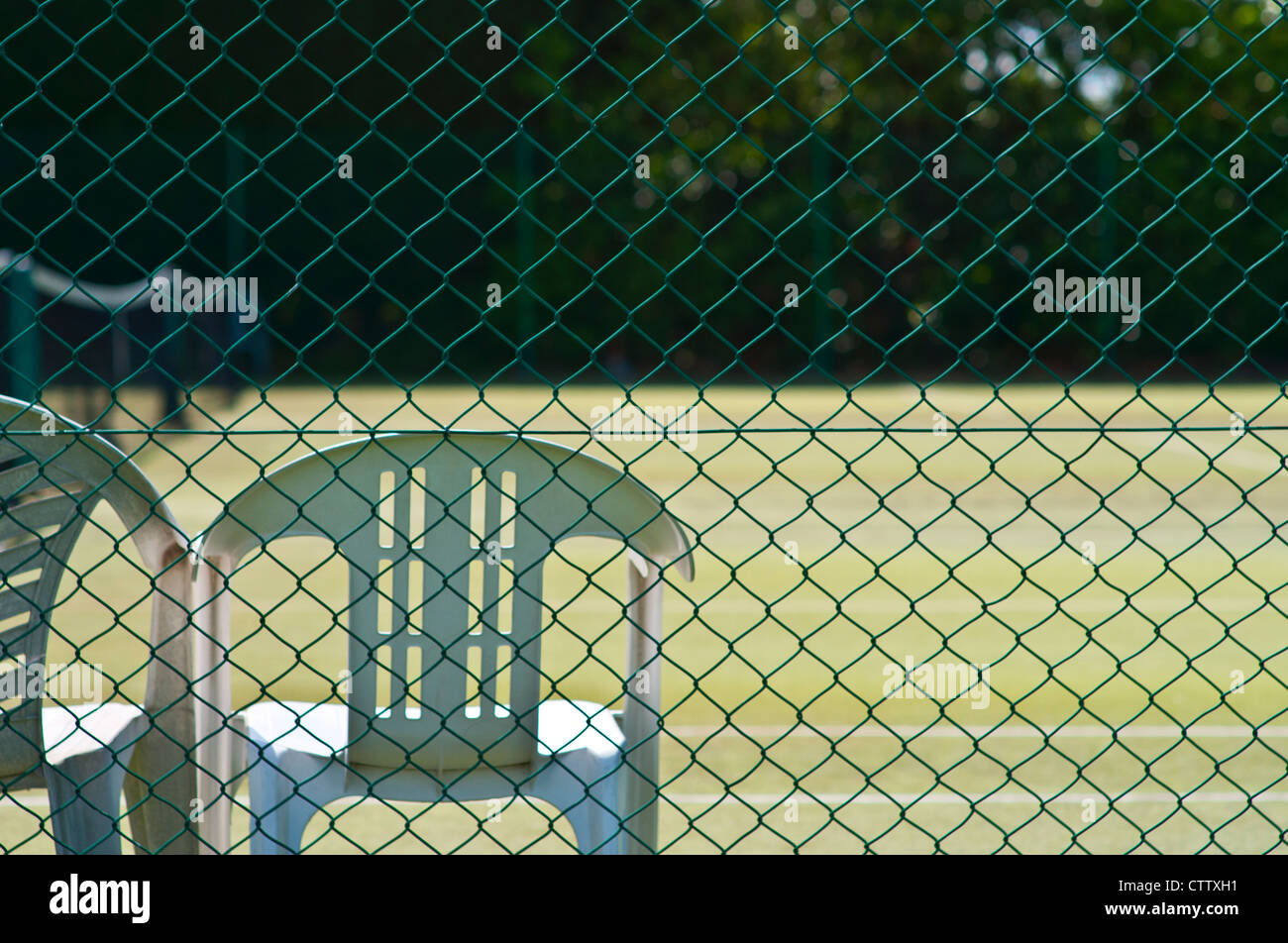 Looking through the perimeter fence onto a tennis court Stock Photo Alamy