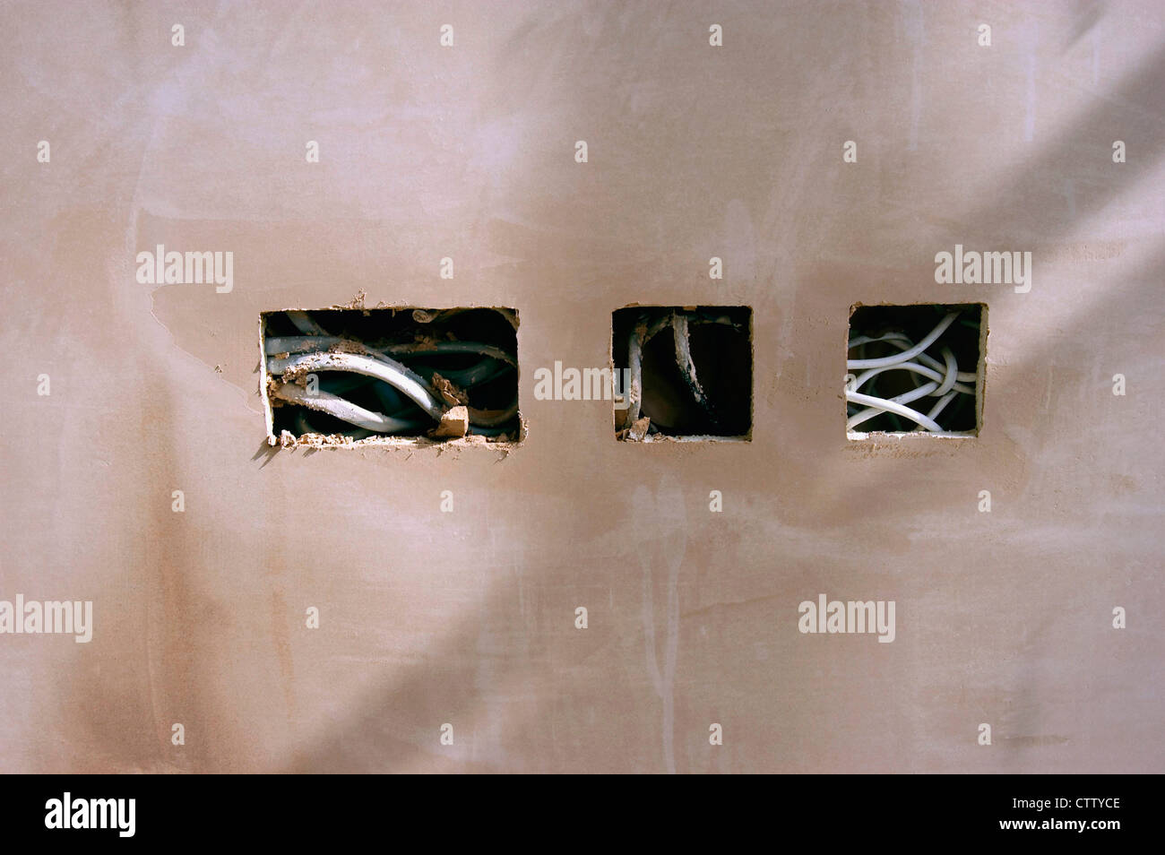 Electrical wires hanging out on a new plastered wall Stock Photo Alamy