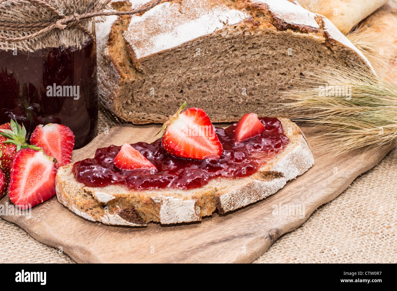 Strawberry Jam with fresh fruits on rustic background Stock Photo - Alamy