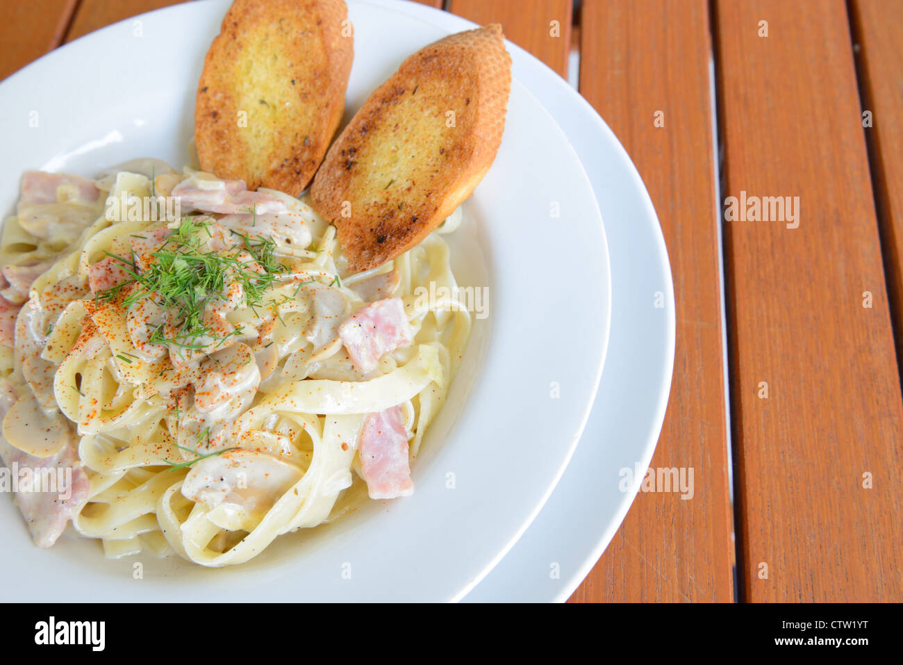 Italian food ,Tagliatelle with Ham and Cheese served on the wooden table Stock Photo