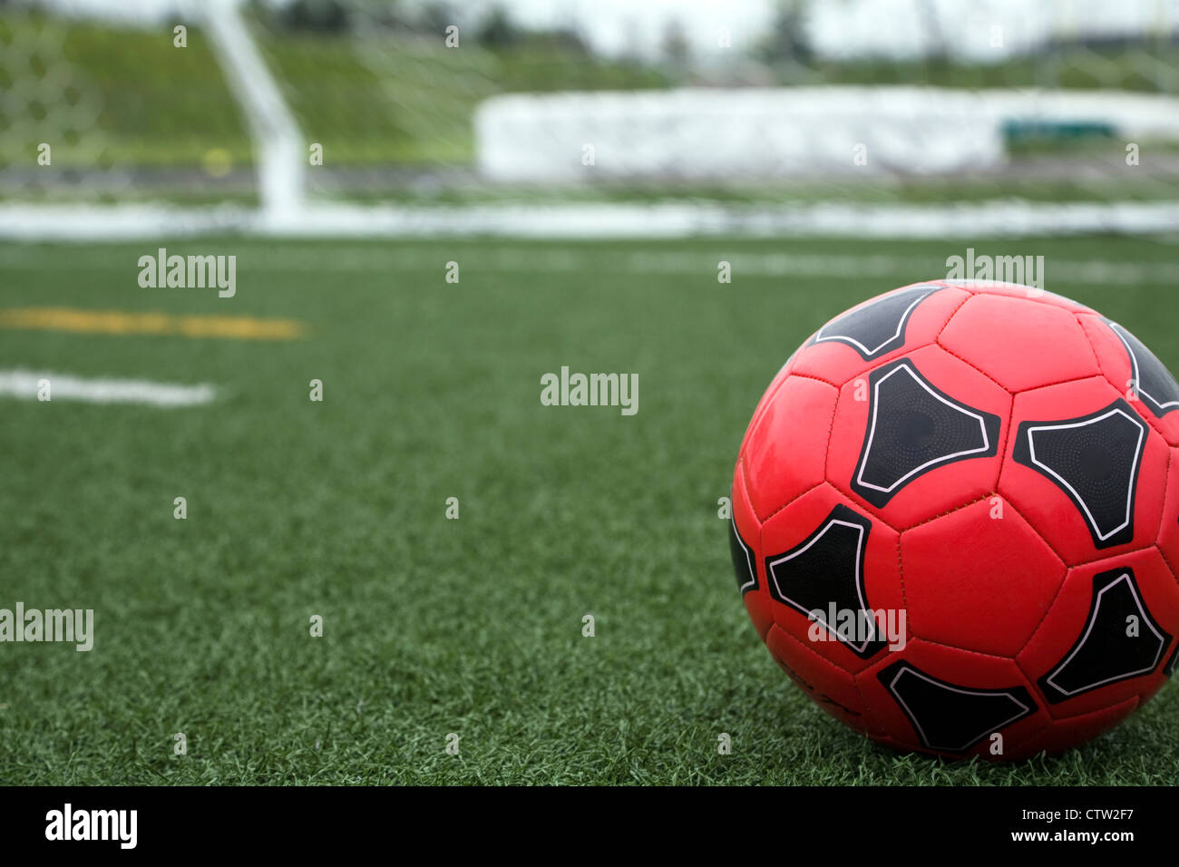 Red Soccer Ball on Field Stock Photo