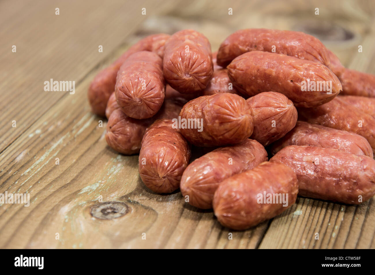 A heap of mini Salamis on wooden background Stock Photo Alamy