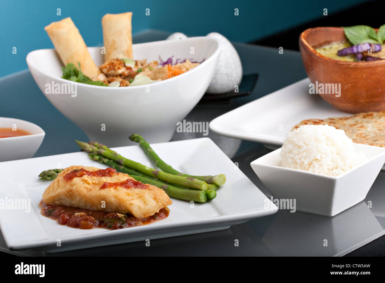 Freshly prepared Thai style sea bass fish dinner with asparagus and appetizer with a contemporary presentation. Stock Photo