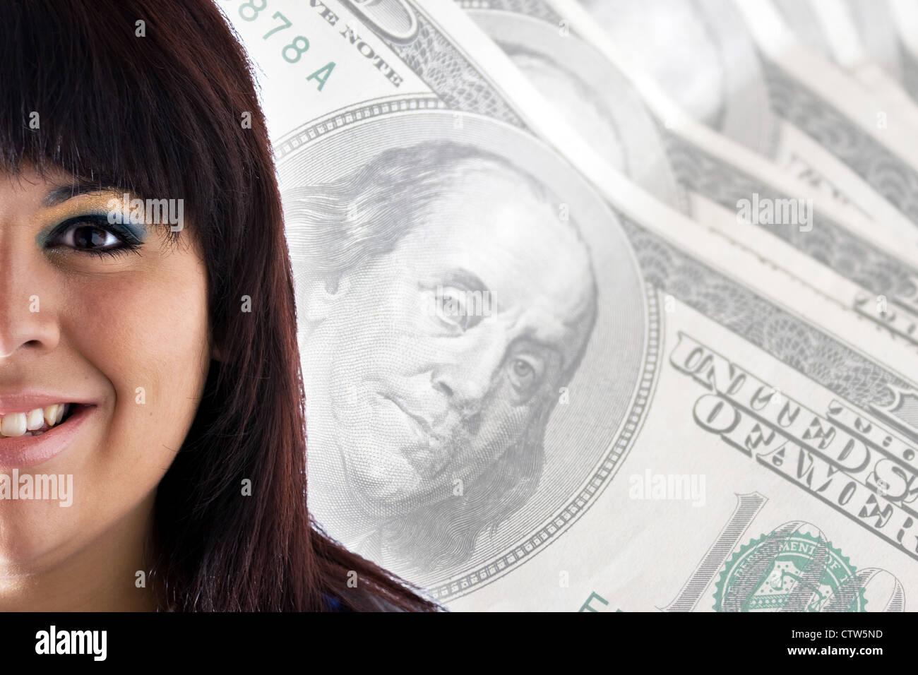 A rich or successful smiling woman in front of a money background with copy space for your text. Stock Photo