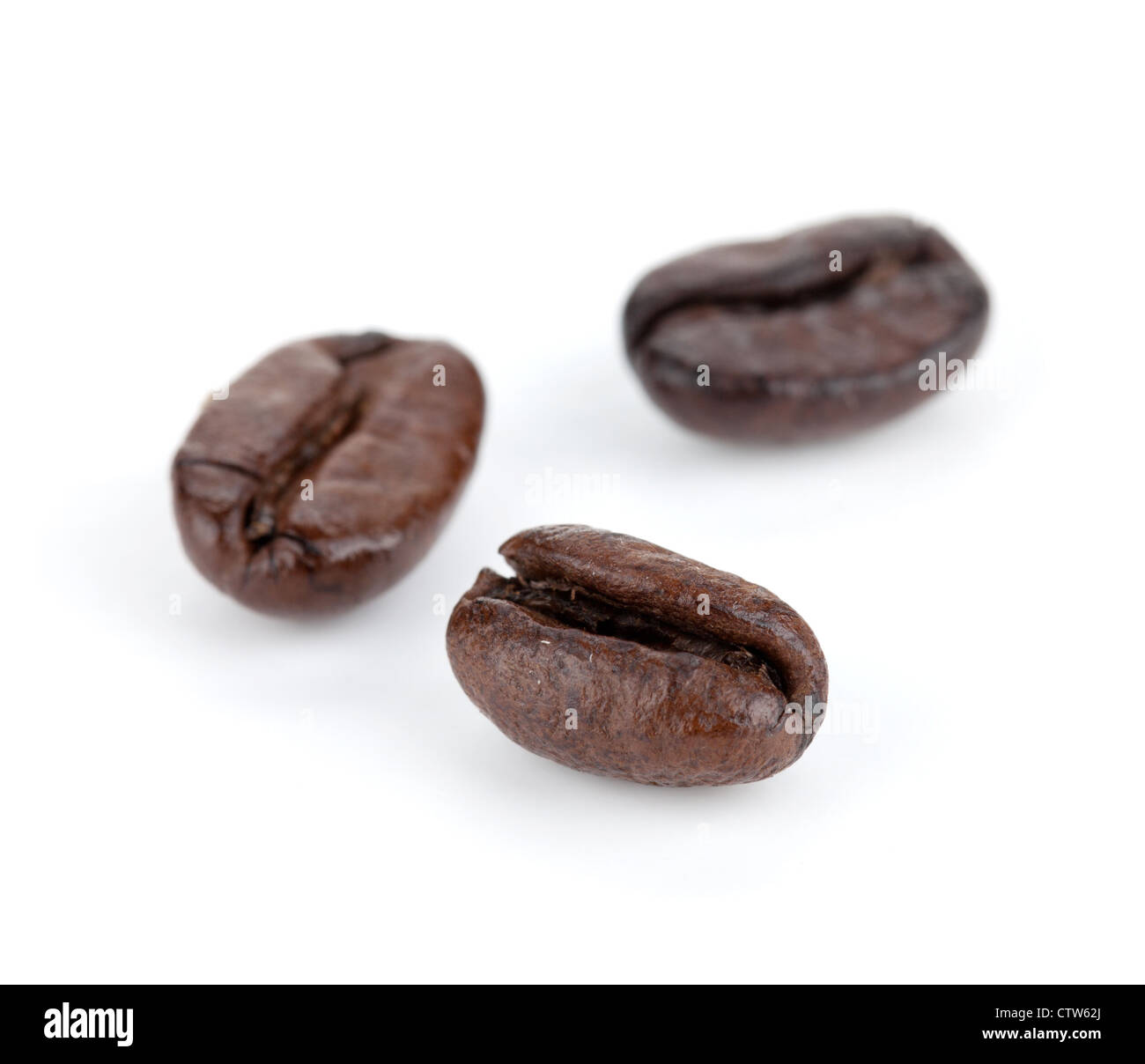 Three coffee beans. Small DOF. Isolated on white background Stock Photo