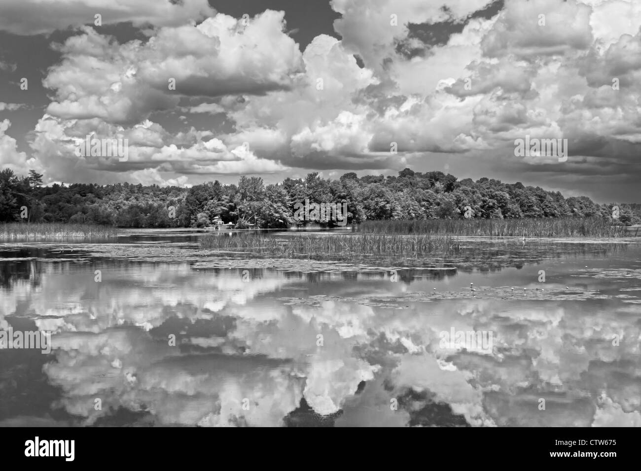 Black and white clouds over Cobbossee Lake Litchfield Maine Stock Photo