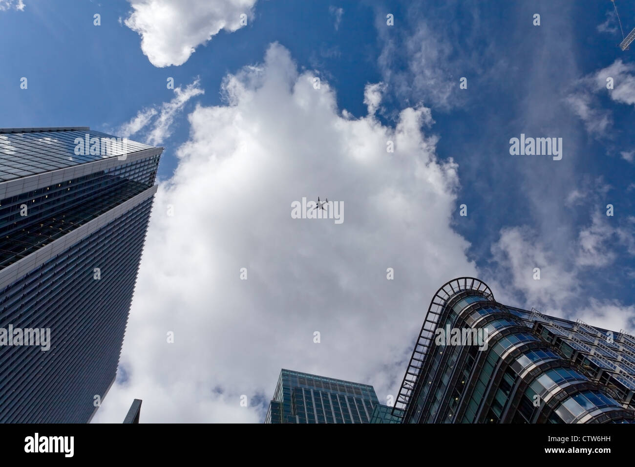 The sky with airplane surrounded by office skyscrapers Stock Photo - Alamy