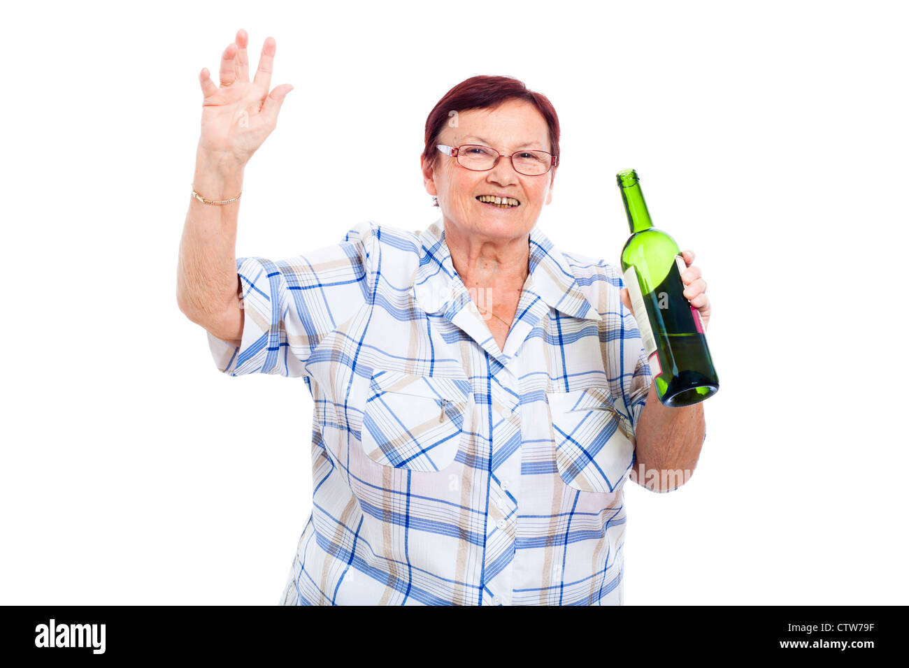 Happy senior drunk woman with bottle of alcohol, isolated on white background. Stock Photo