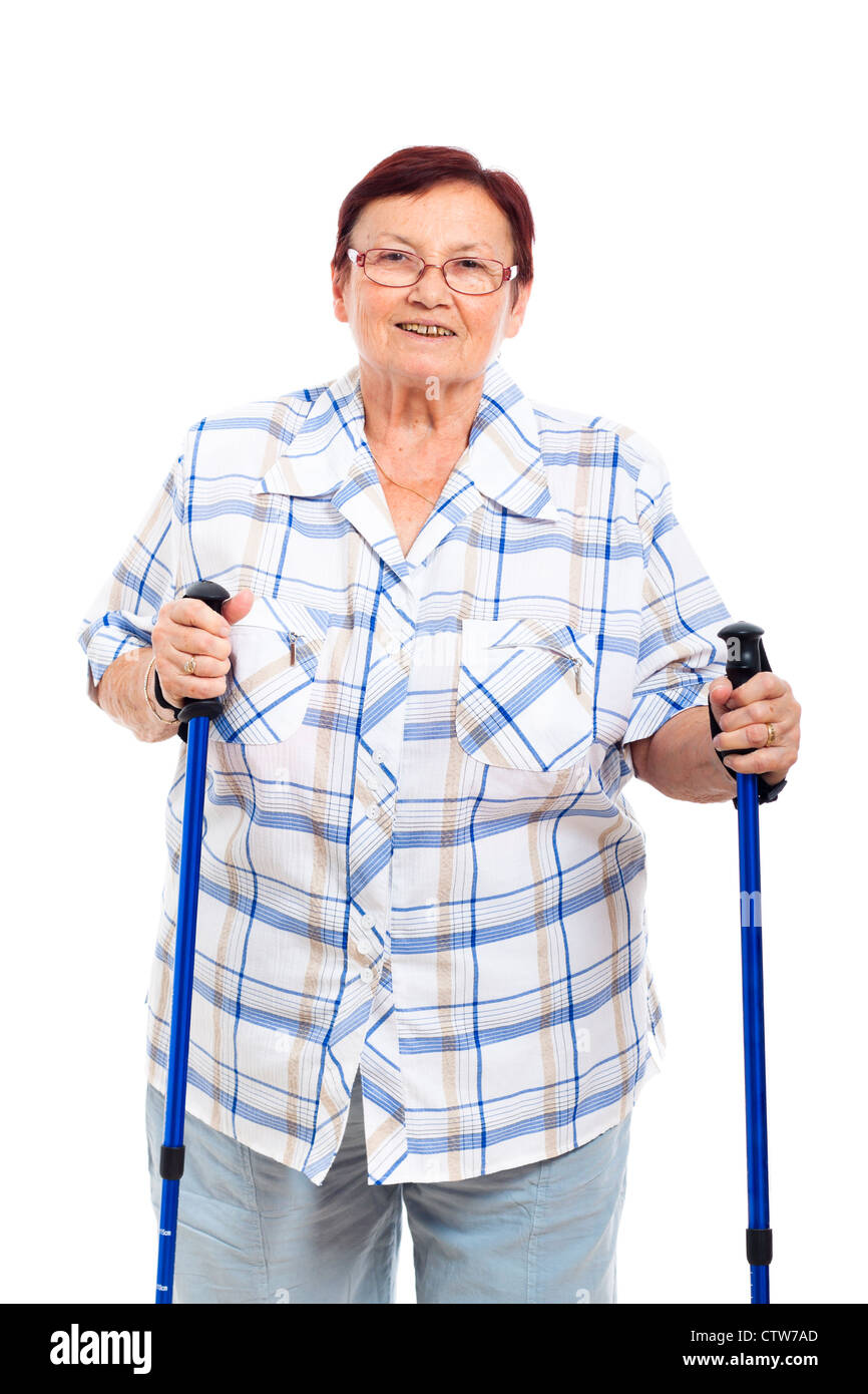 Portrait of happy smiling senior woman with walking sticks, isolated on white background. Stock Photo
