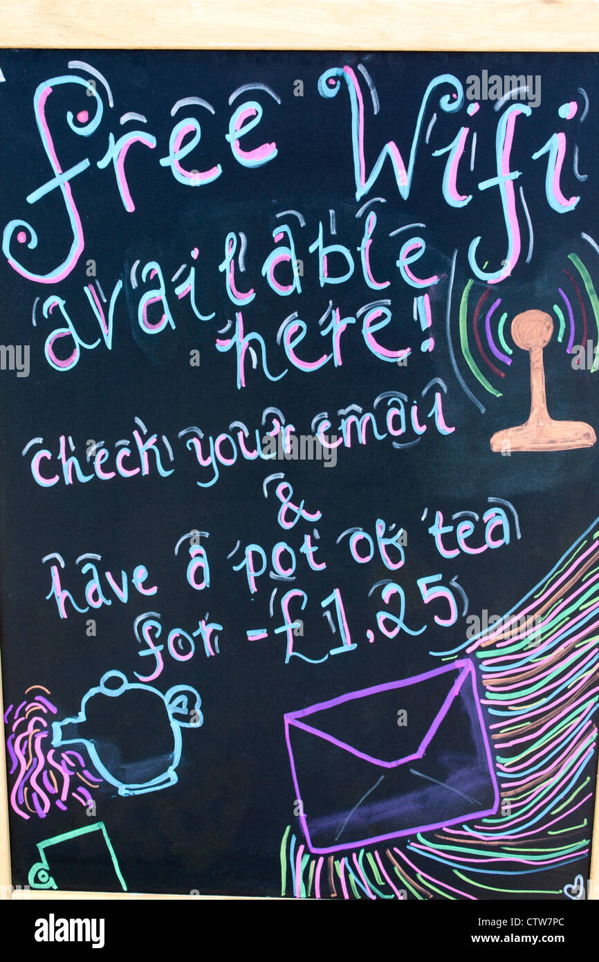 Free Wifi sign on chalkboard outside cafe with drawings of teapot and envelope and price for pot