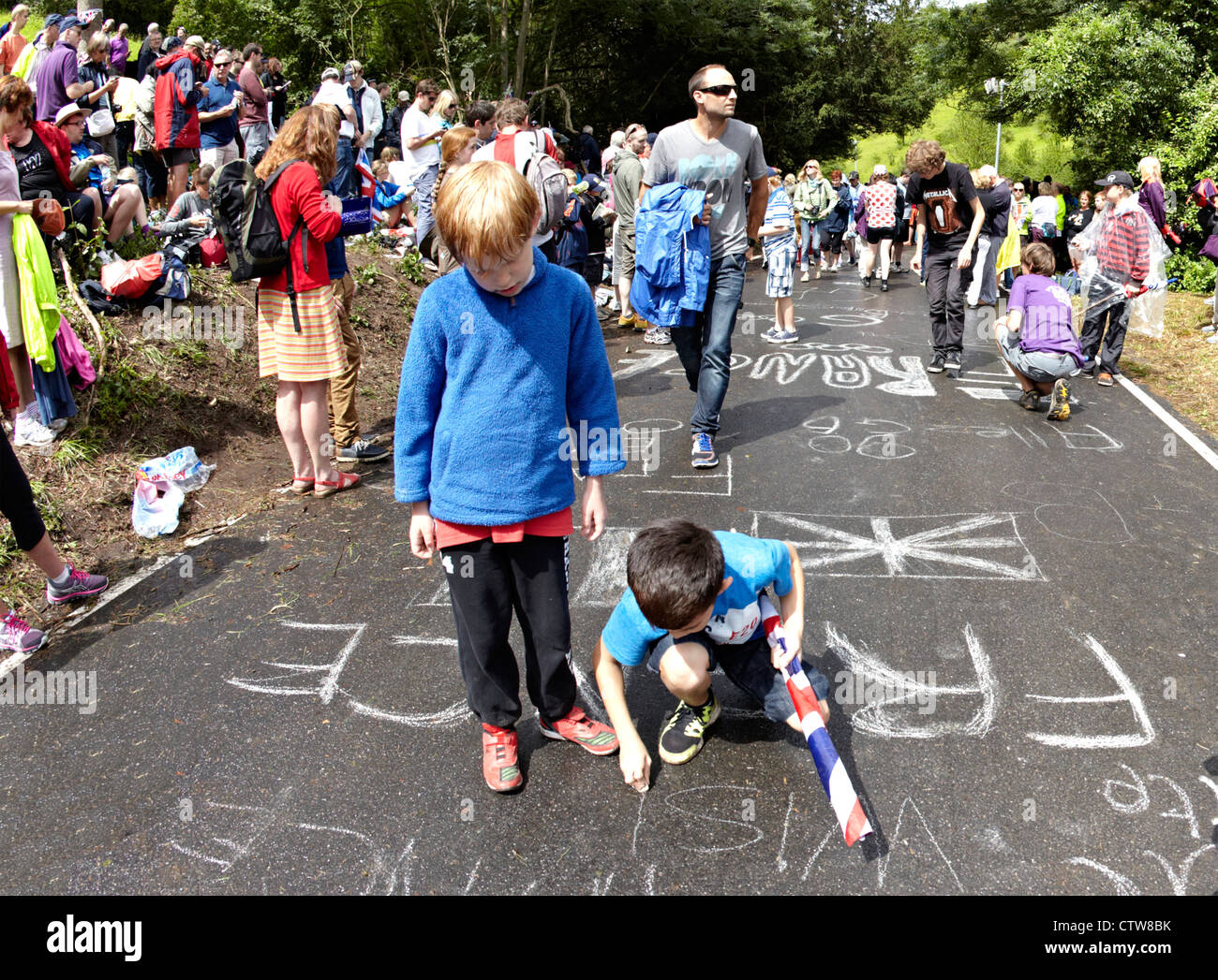 Boys Writing On the Cycle Track For the Road Race at Box Hill 2012 Olympics Stock Photo