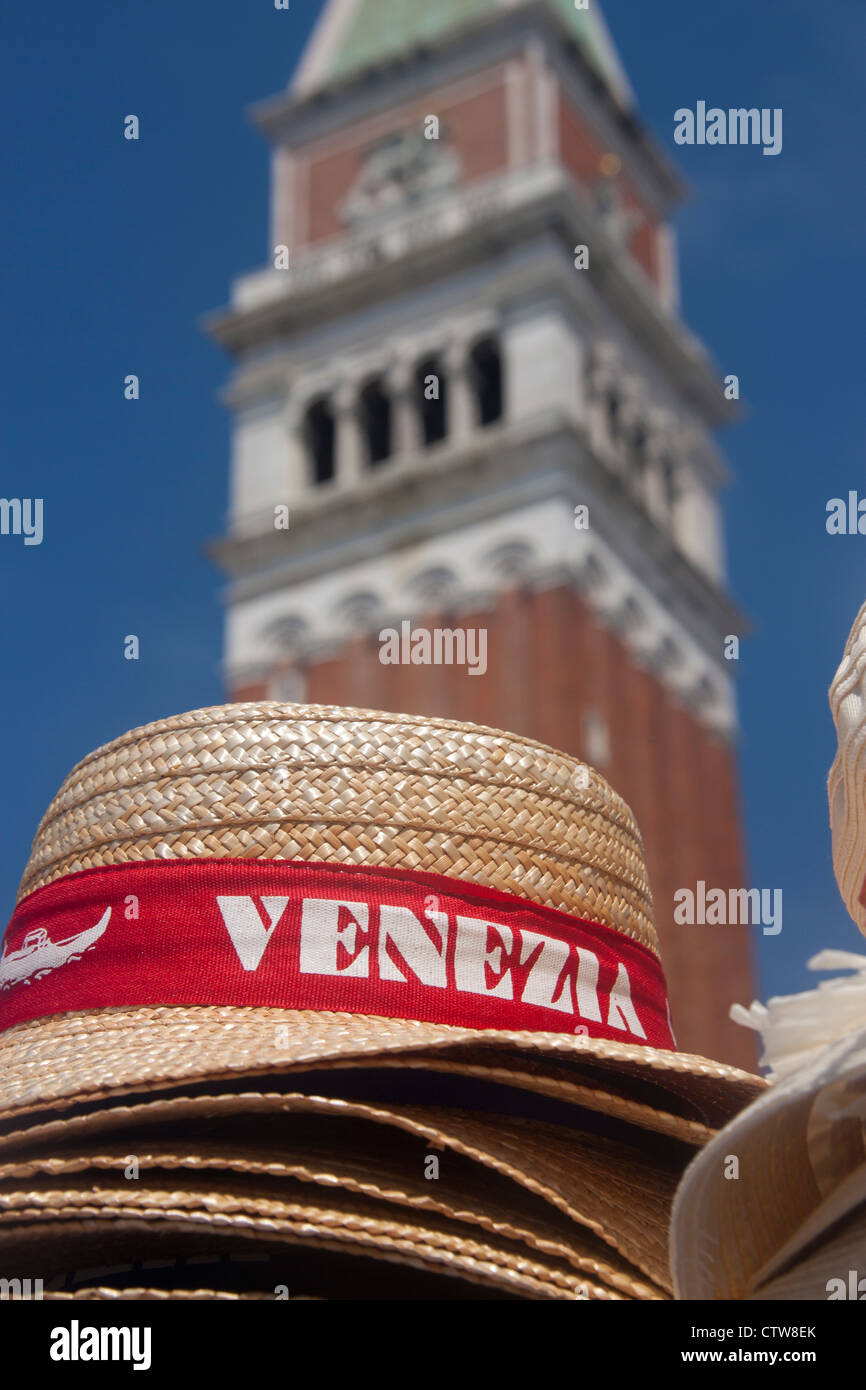 Souvenir Venezia straw hats with St Mark's (San Marco) campanile in background Venice Veneto Italy Stock Photo