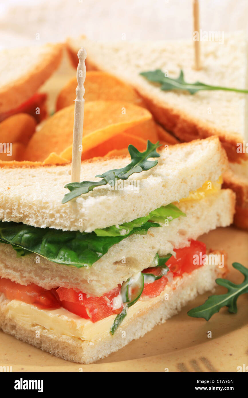 Vegetable sandwich triangles and spicy crisps Stock Photo Alamy
