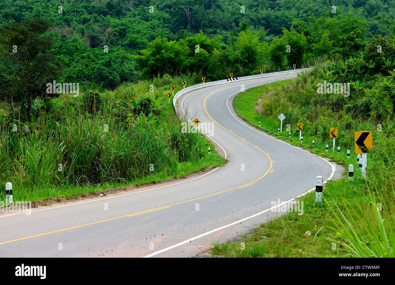 The S curve asphalt road is go up to the hill. Stock Photo